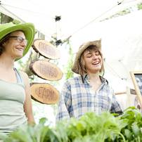 Green Things Farms co-owner Jill Lada and employee Sarah Alexander (left to right) sell merchandise during the Cobblestone Farm Farmers Market on Tuesday, May 21. Daniel Brenner I AnnArbor.com